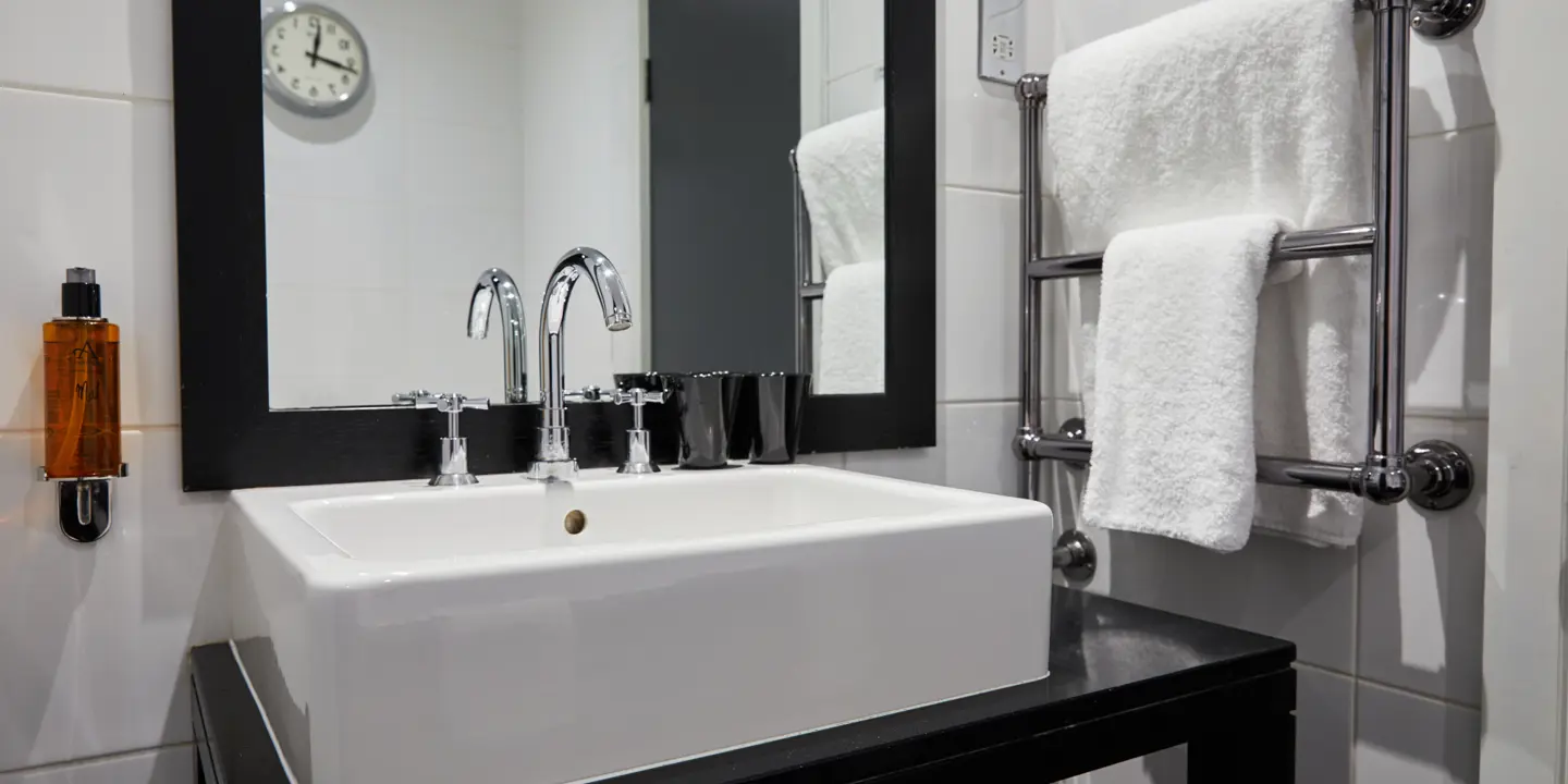 White sink positioned beneath a mirror in a bathroom.