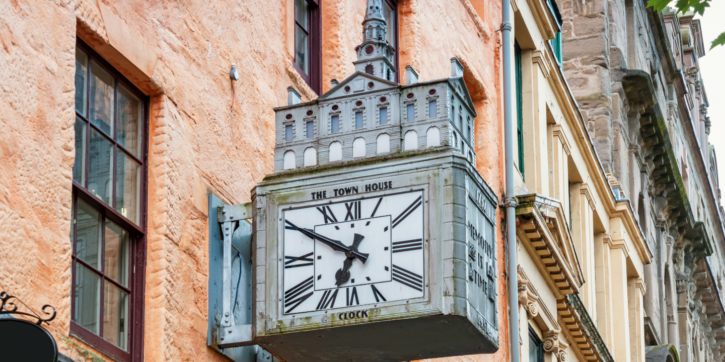 A clock attached to the side of a building.