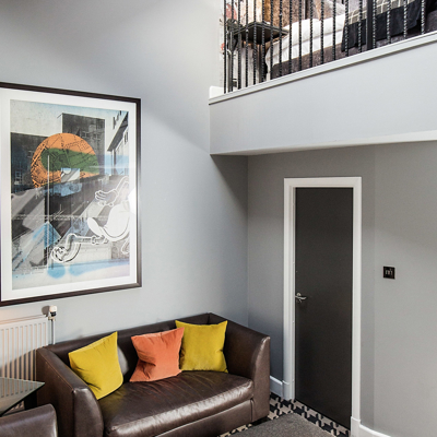 A well-furnished living room with a balcony.