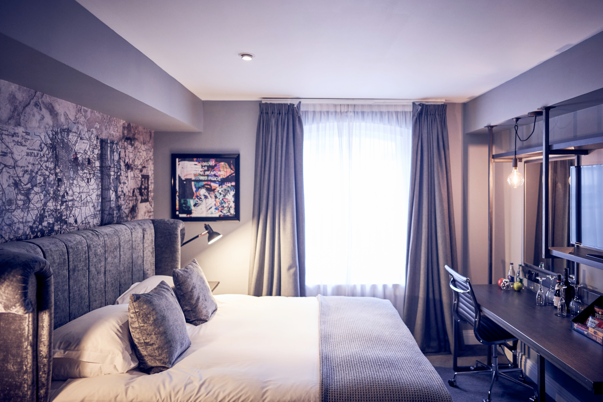 Bedroom featuring a grey velvet bed and chair.