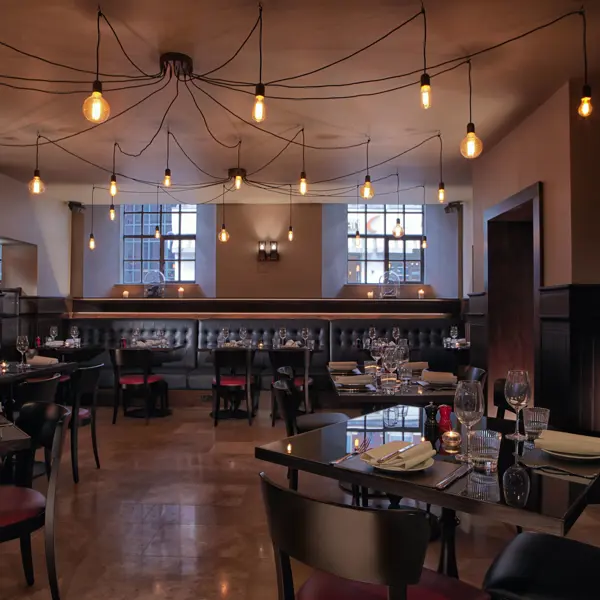 A restaurant featuring numerous tables and chairs.