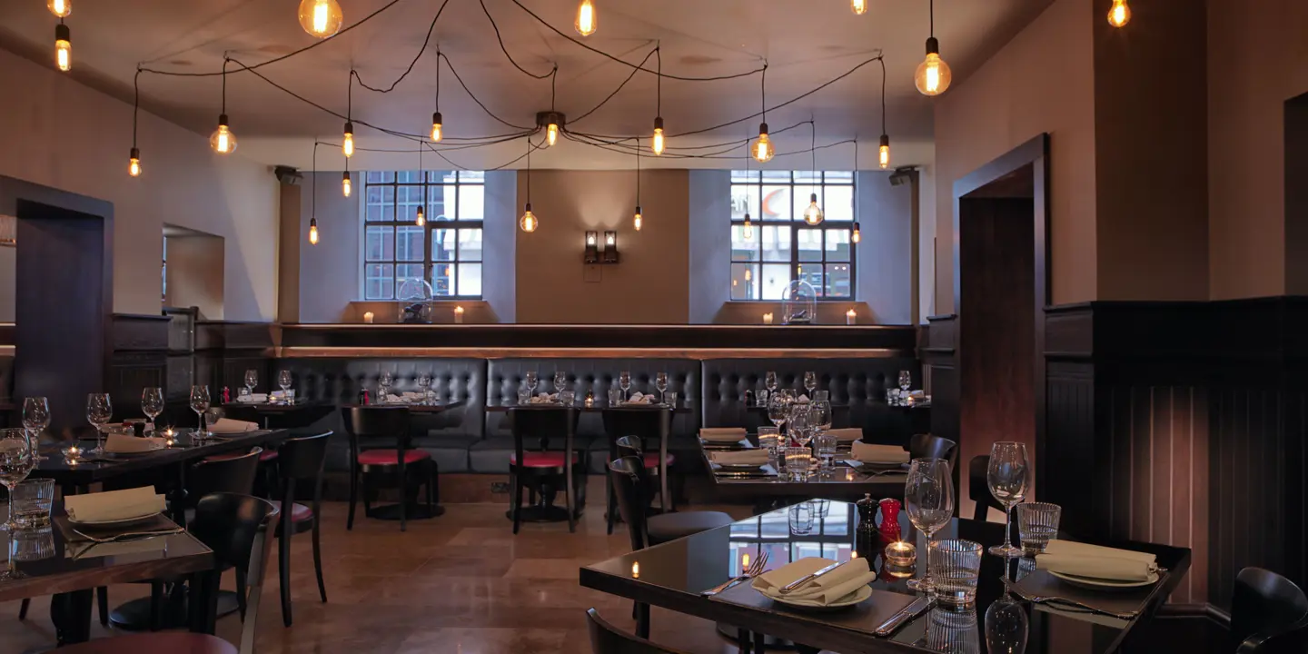 A restaurant featuring numerous tables and chairs.