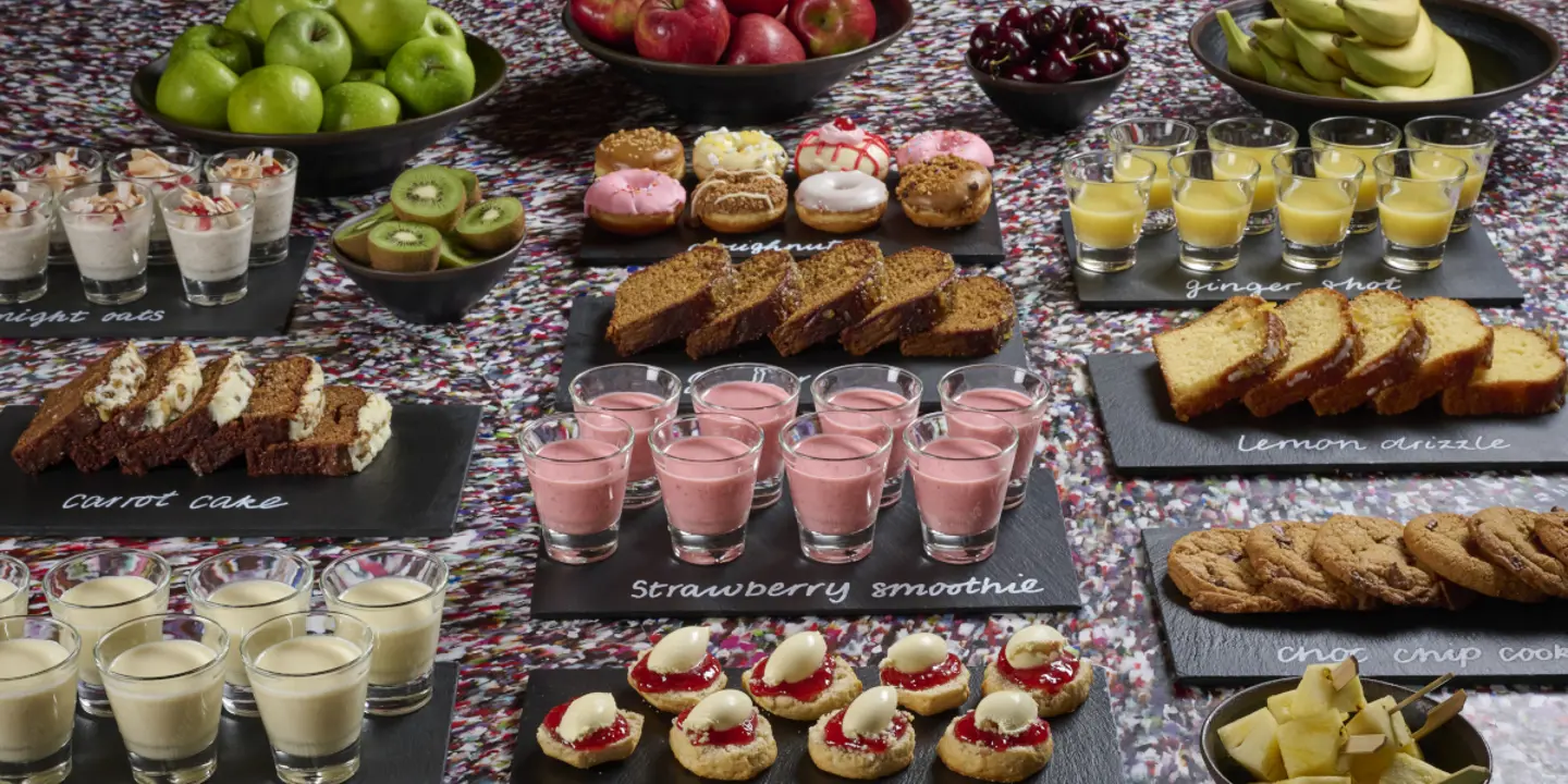 Tray of food displayed on a table in front of a captivating mural.