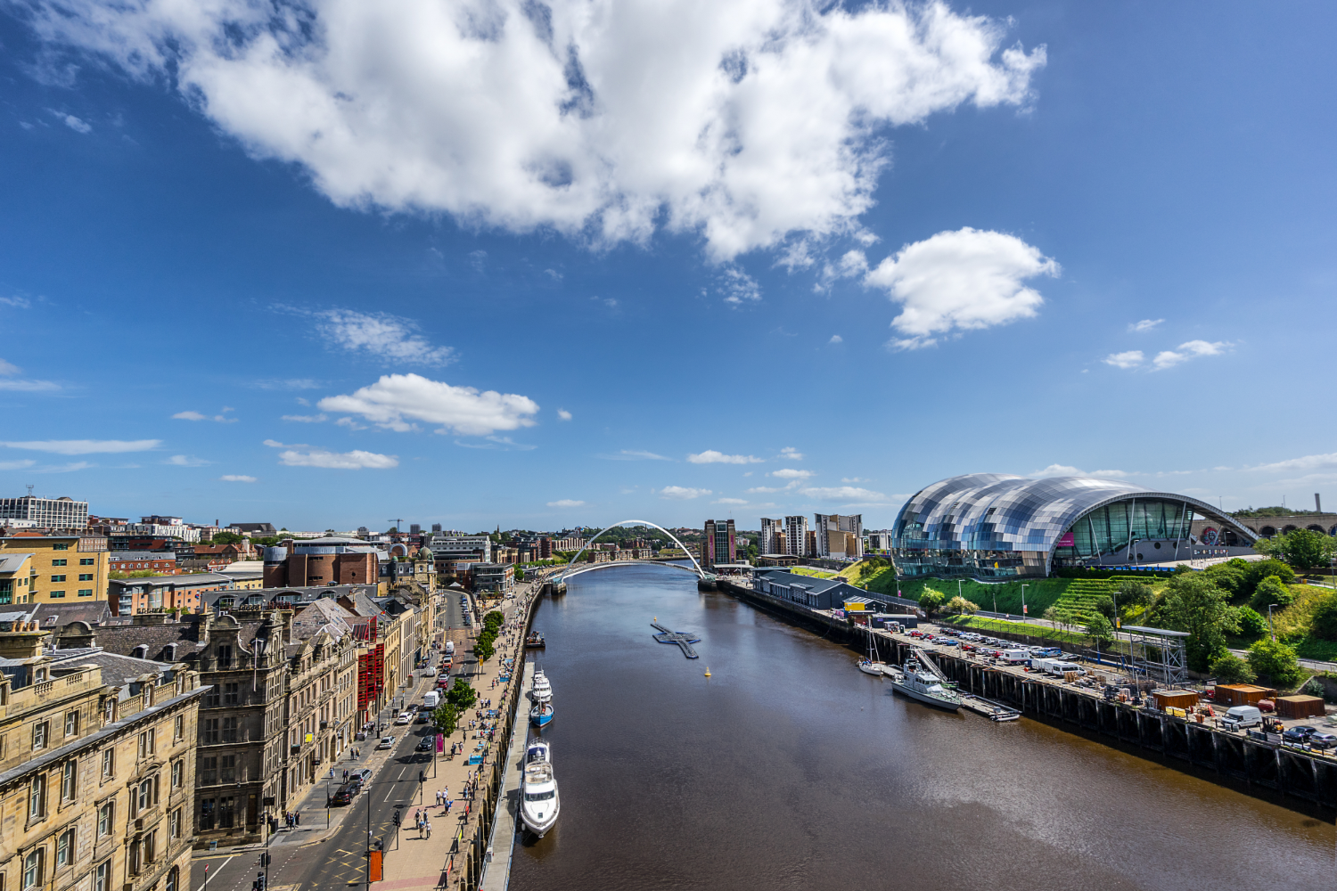 River flowing through urban landscape with towering buildings.
