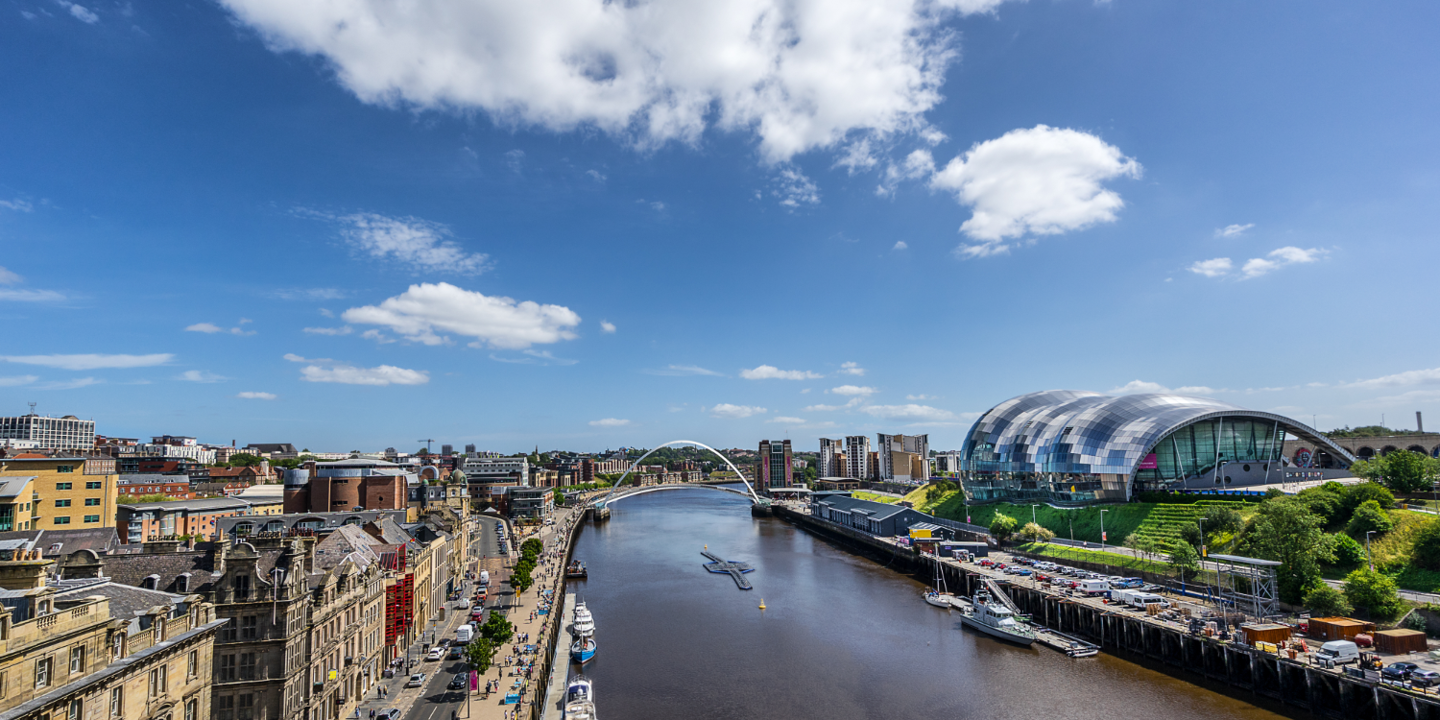 River flowing through urban landscape with towering buildings.