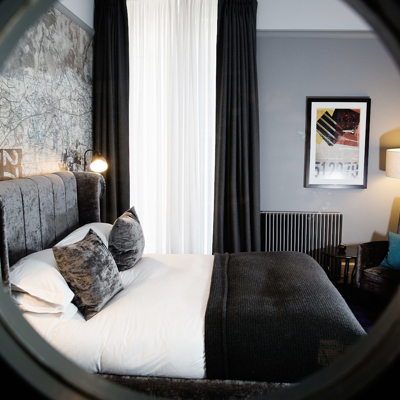 View of a bedroom through a round window.