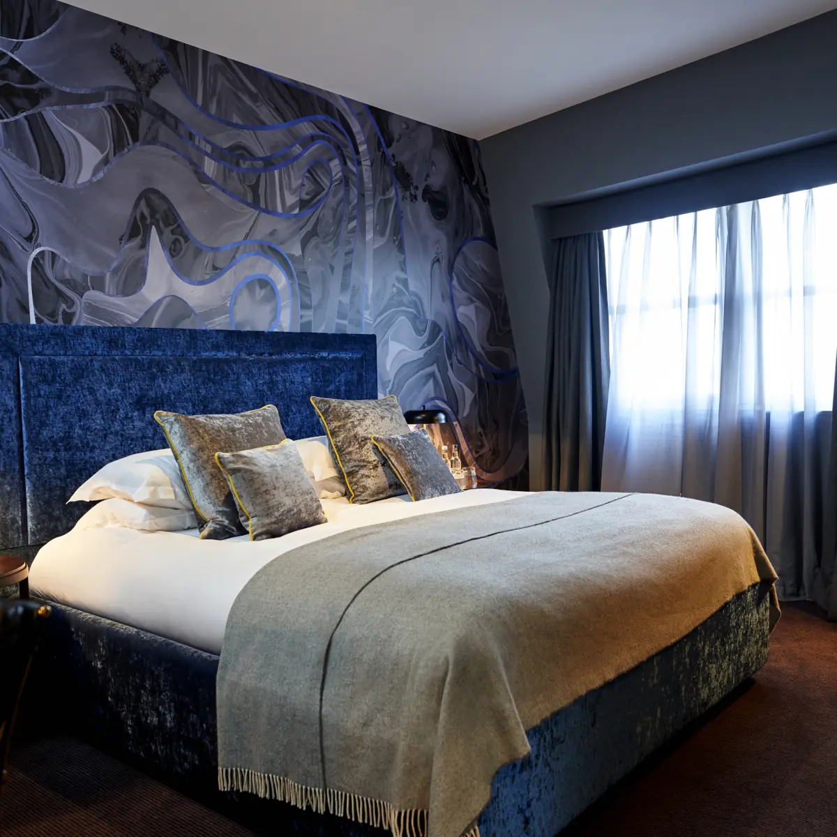 Bedroom featuring a comfortable bed and chair.