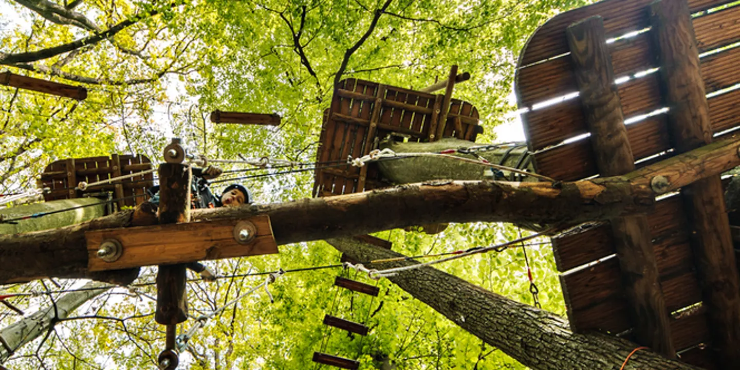 A wooden structure with a group of people riding on top.