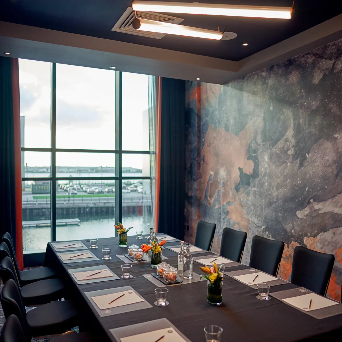 A table set with place settings and a cityscape in the background.