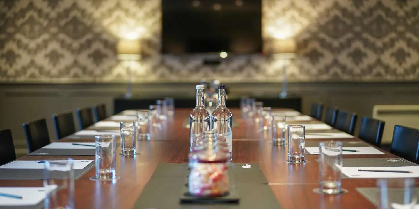 A wooden table with a bottle of water placed on top.