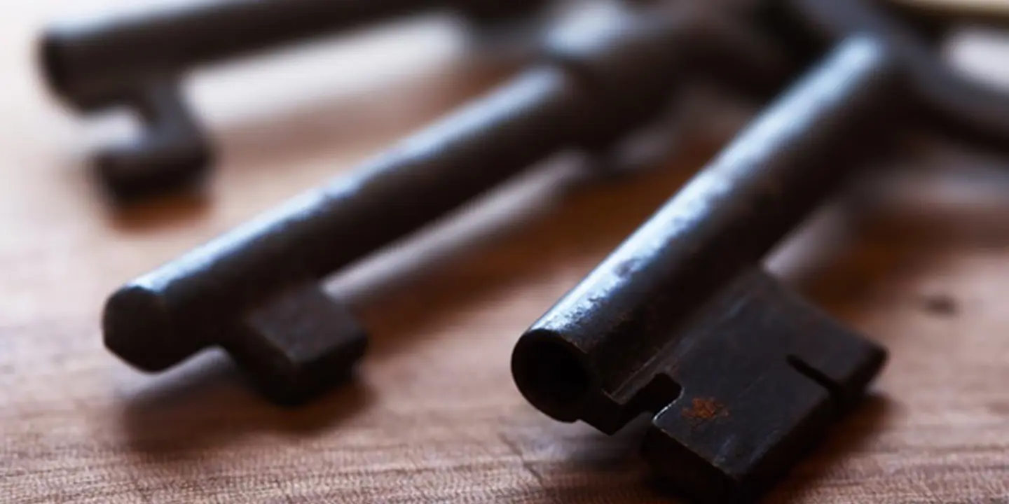 Keys arranged neatly on a wooden table.