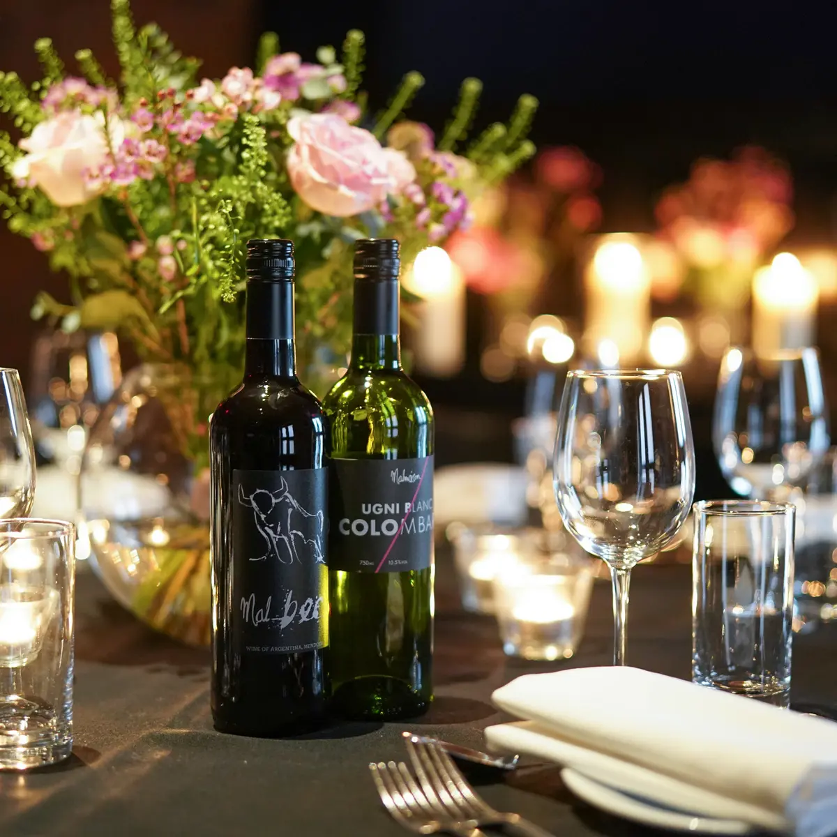 A bottle of wine resting on a table.