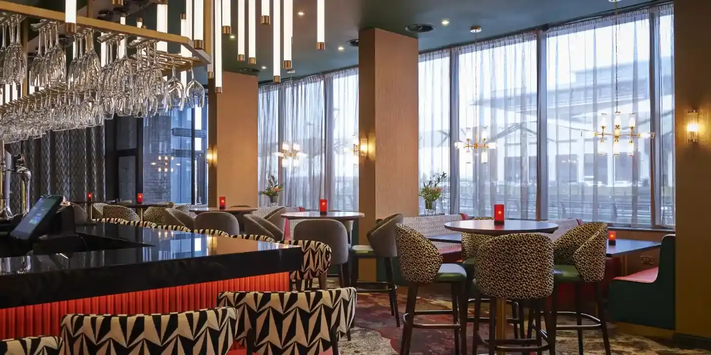 A bar adorned with numerous chairs and tables.