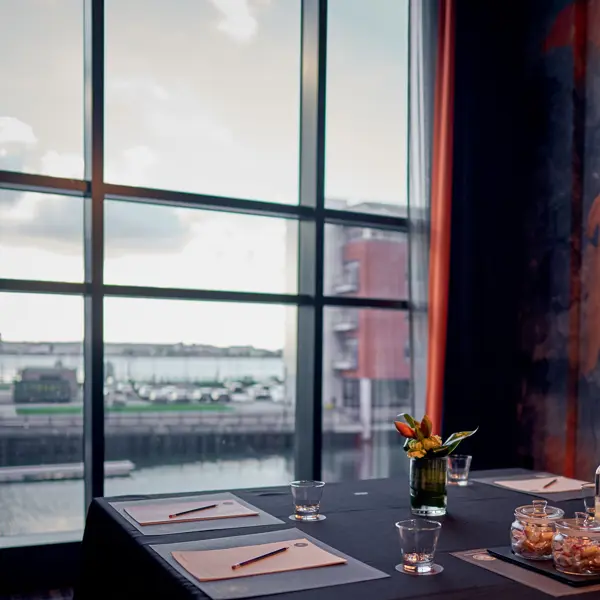 Table with a vase containing flowers.