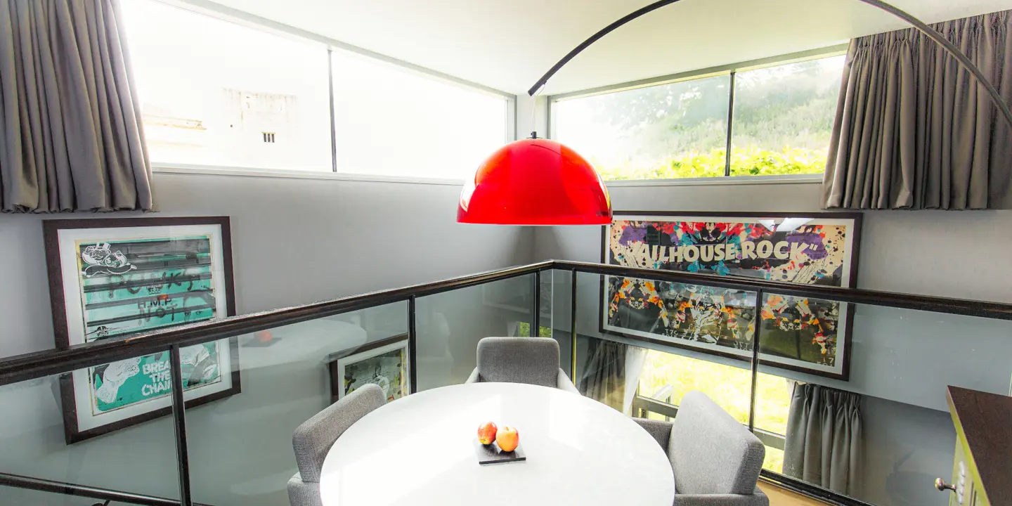 A white table with a red lamp above.