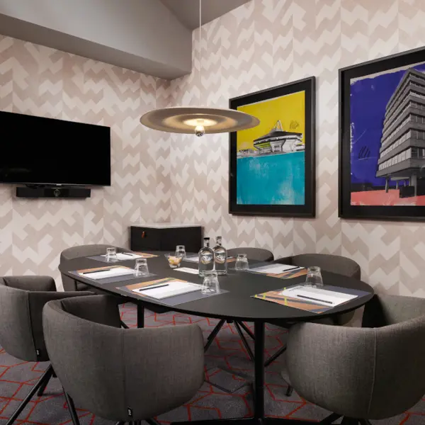 Conference room featuring a table and chairs.