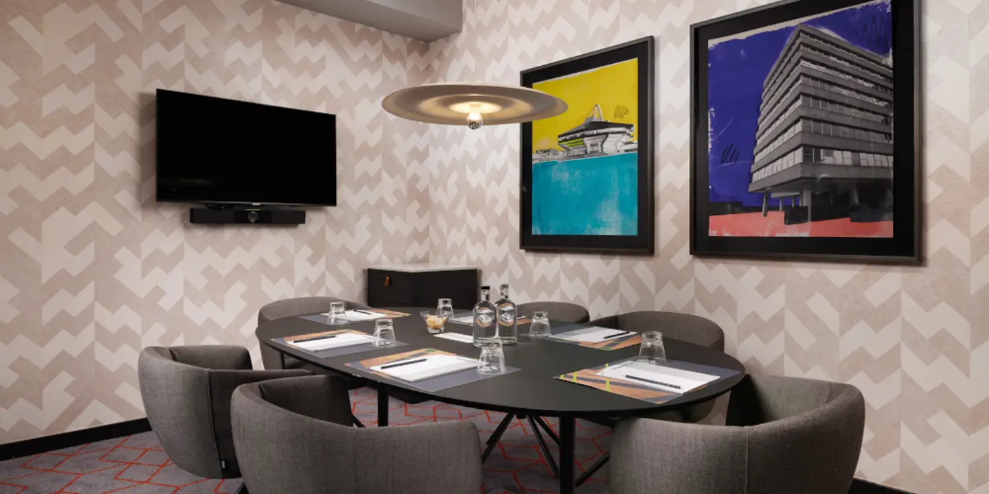 Conference room featuring a table and chairs.