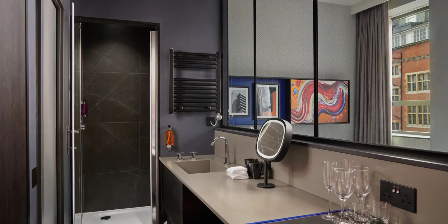 Bathroom with walk in shower and sink.