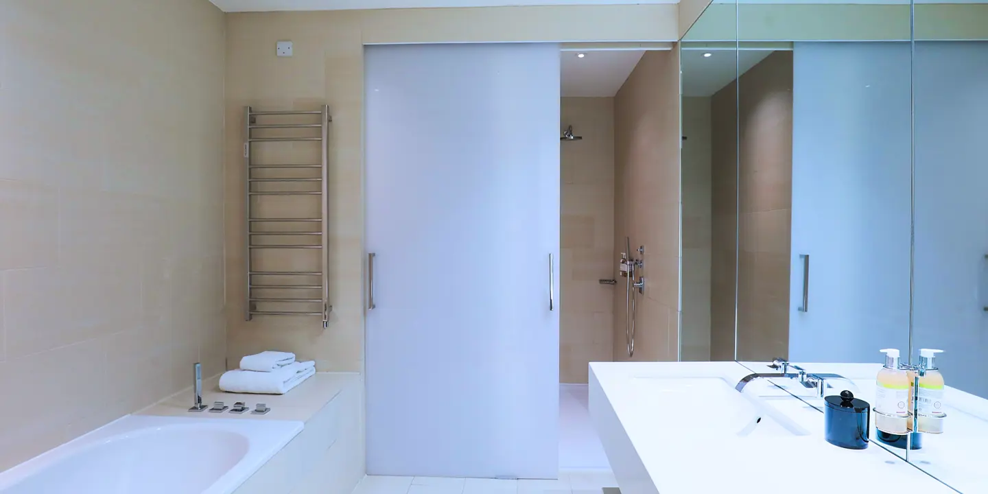 Bathroom featuring dual sinks and a bath.