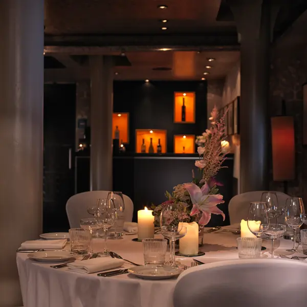 A beautifully arranged table for a formal dinner, adorned with elegant candles.