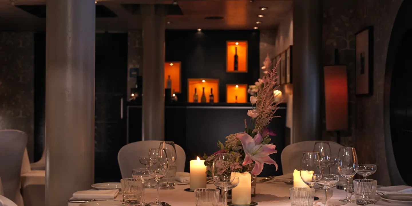 A beautifully arranged table for a formal dinner, adorned with elegant candles.