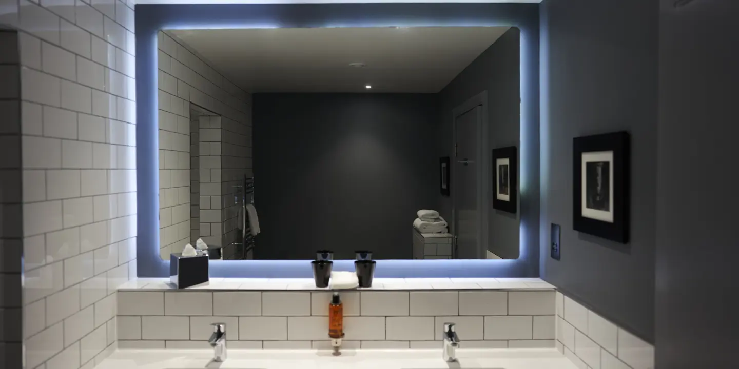 Bathroom featuring two sinks and a spacious mirror.