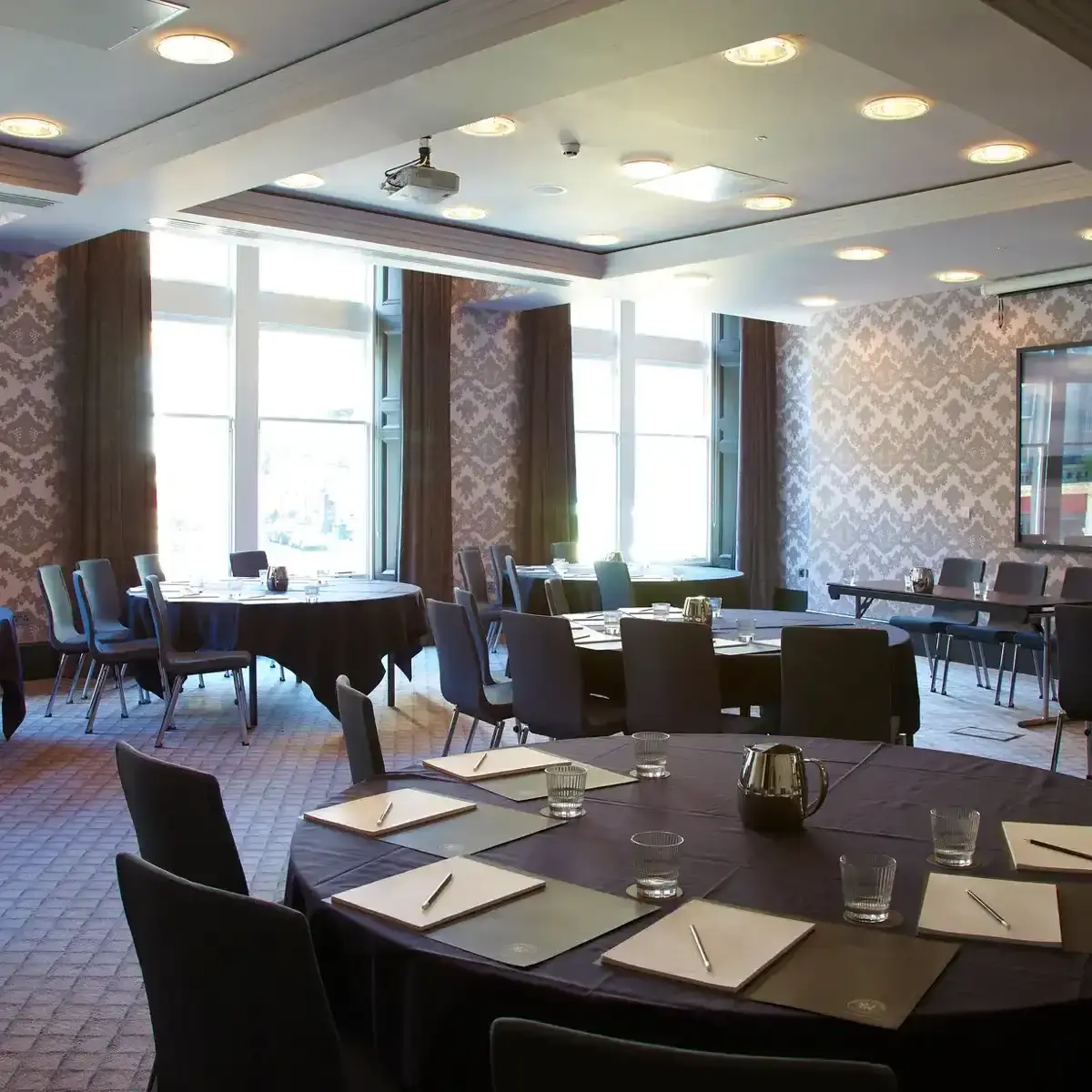 A dining room featuring a round table and chairs.