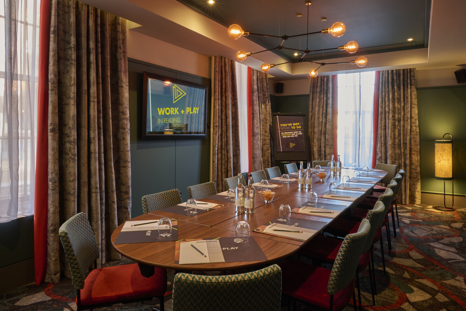 A beautiful meeting room with place settings, ready for business