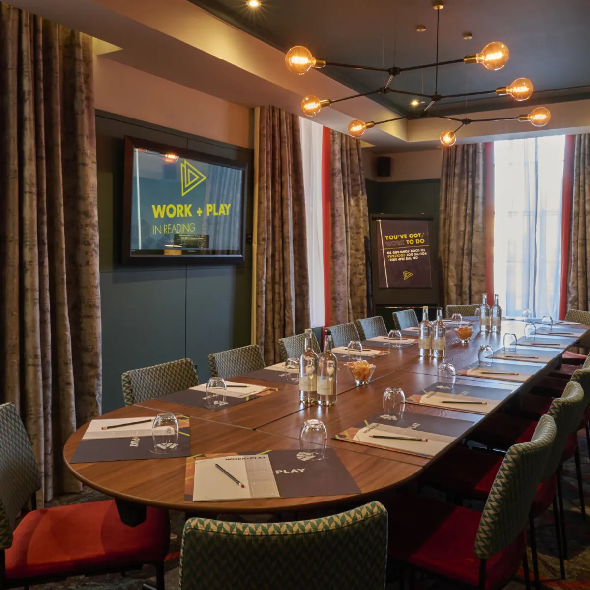 A beautiful meeting room with place settings, ready for business