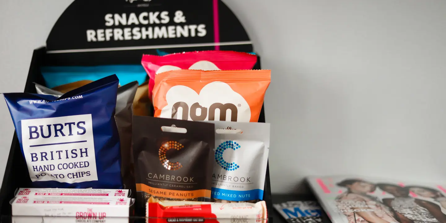 Assortment of snacks and beverages showcased on a shelf.