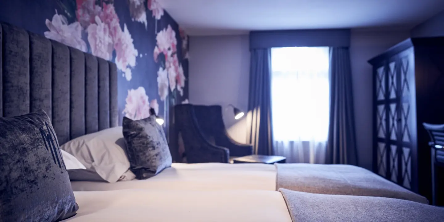 Bedroom featuring a comfortable bed and chair.