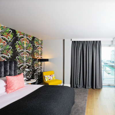 Spacious bedroom featuring a king-sized bed and a charming balcony.