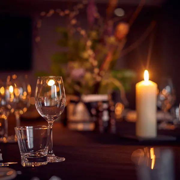 A beautifully arranged table adorned with elegant wine glasses and gleaming silverware.