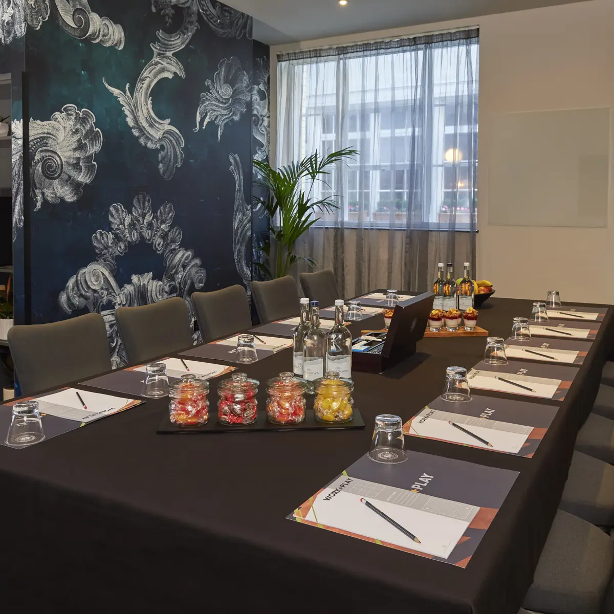 A well-arranged meeting table is displayed.