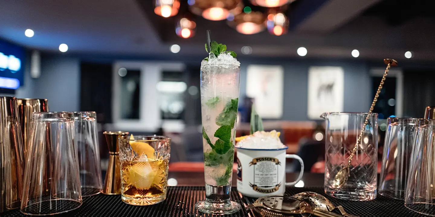 An assortment of various beverages displayed at a bar.