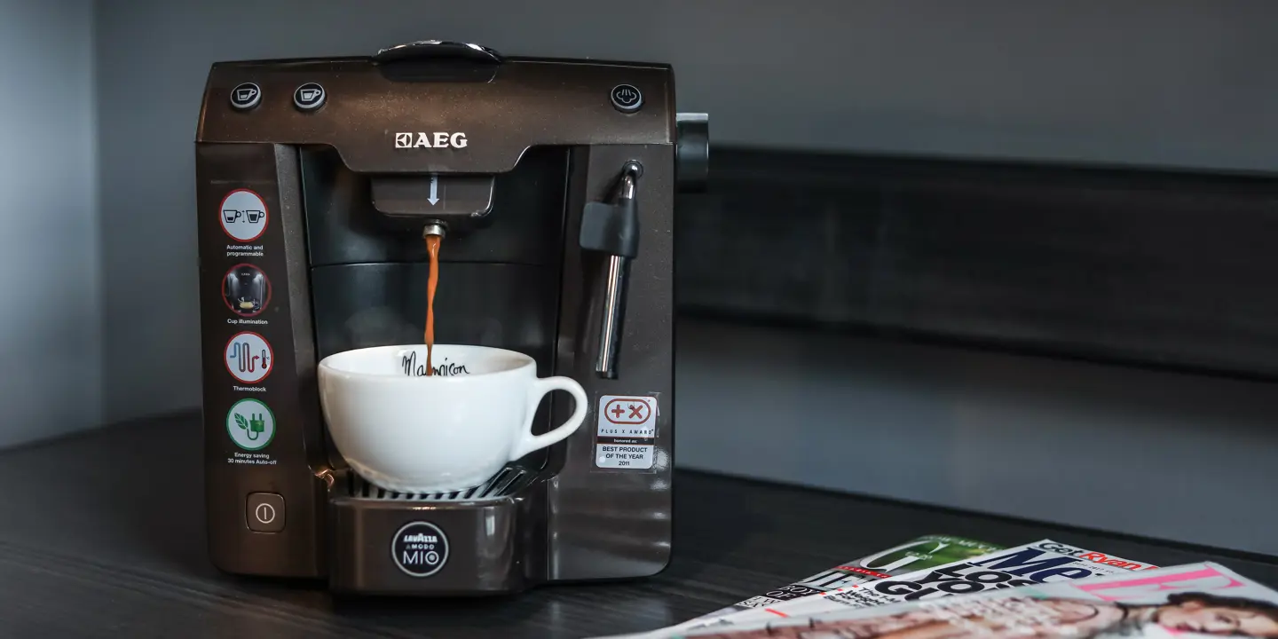 Coffee maker on wooden table.