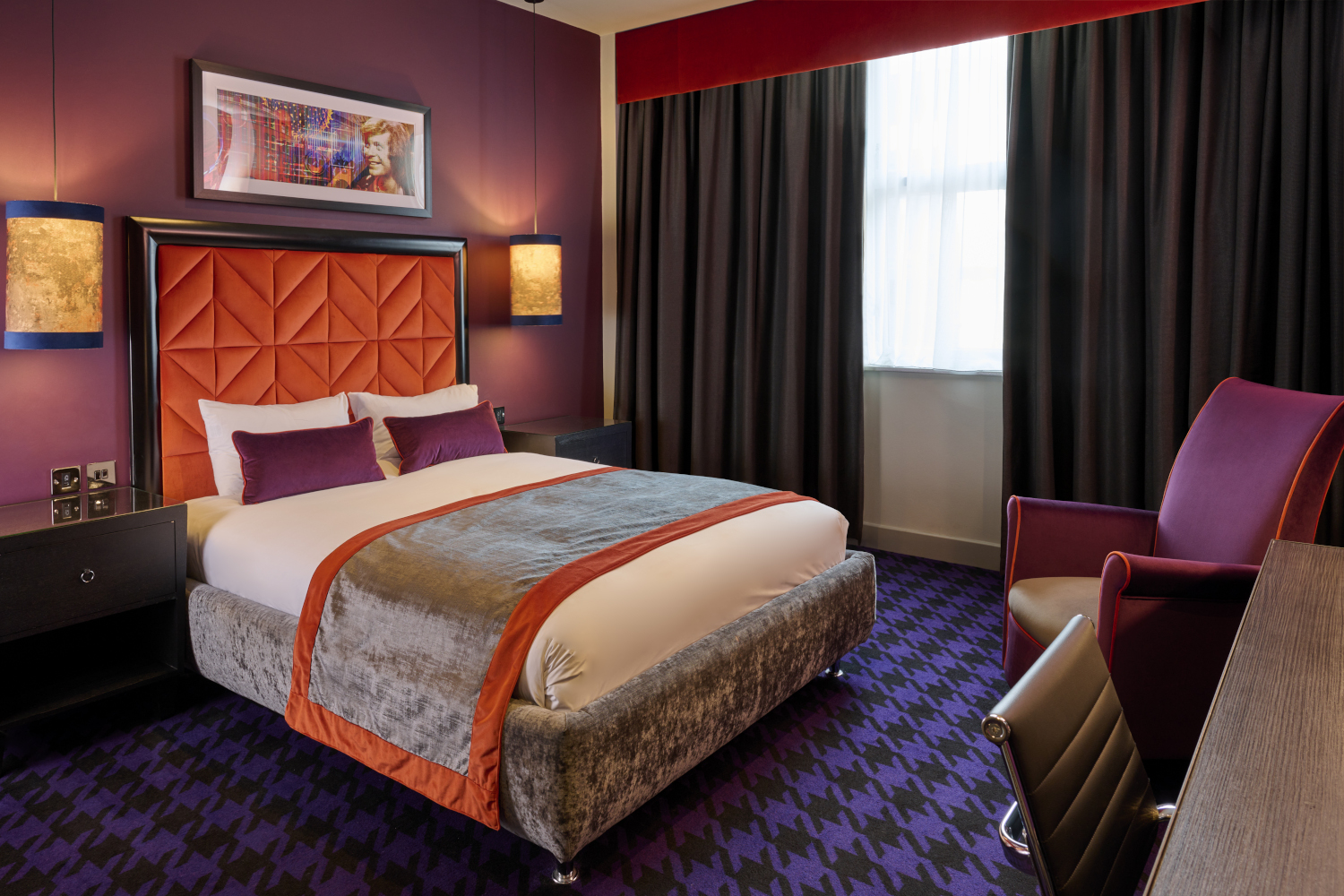 An elegantly designed bed with two plush pillows and an elegant headboard.