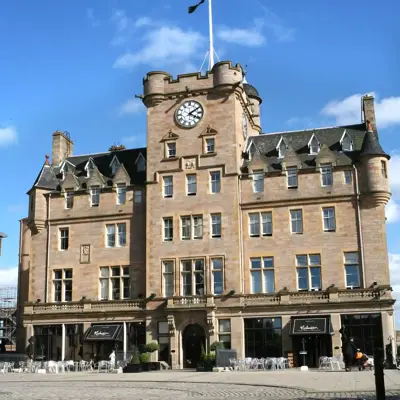 An imposing structure featuring a prominent clock atop.