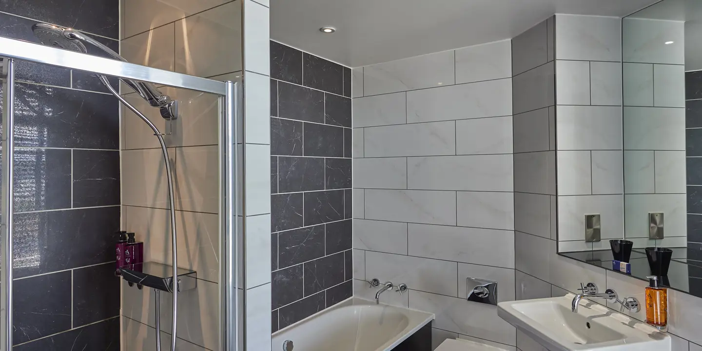 A bathroom featuring a sink, toilet, and bathtub.