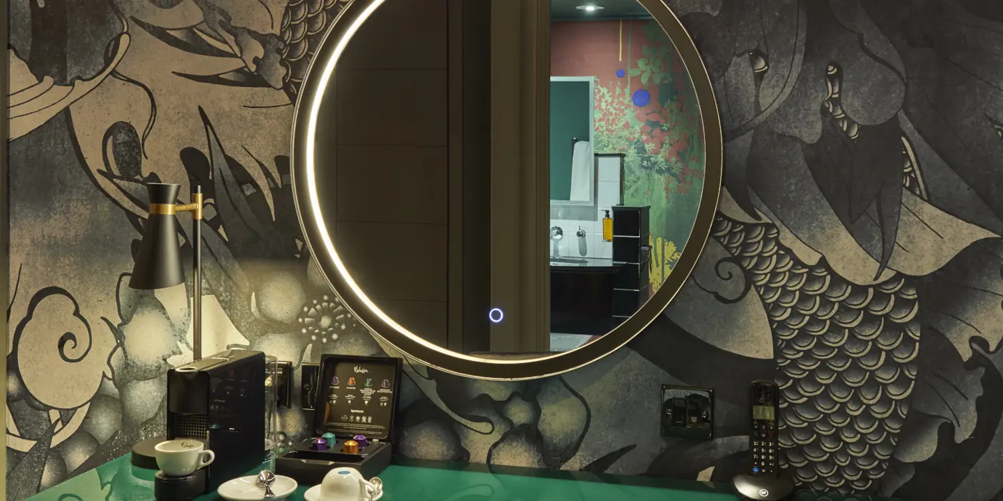 A bathroom featuring a green countertop and a mirror.