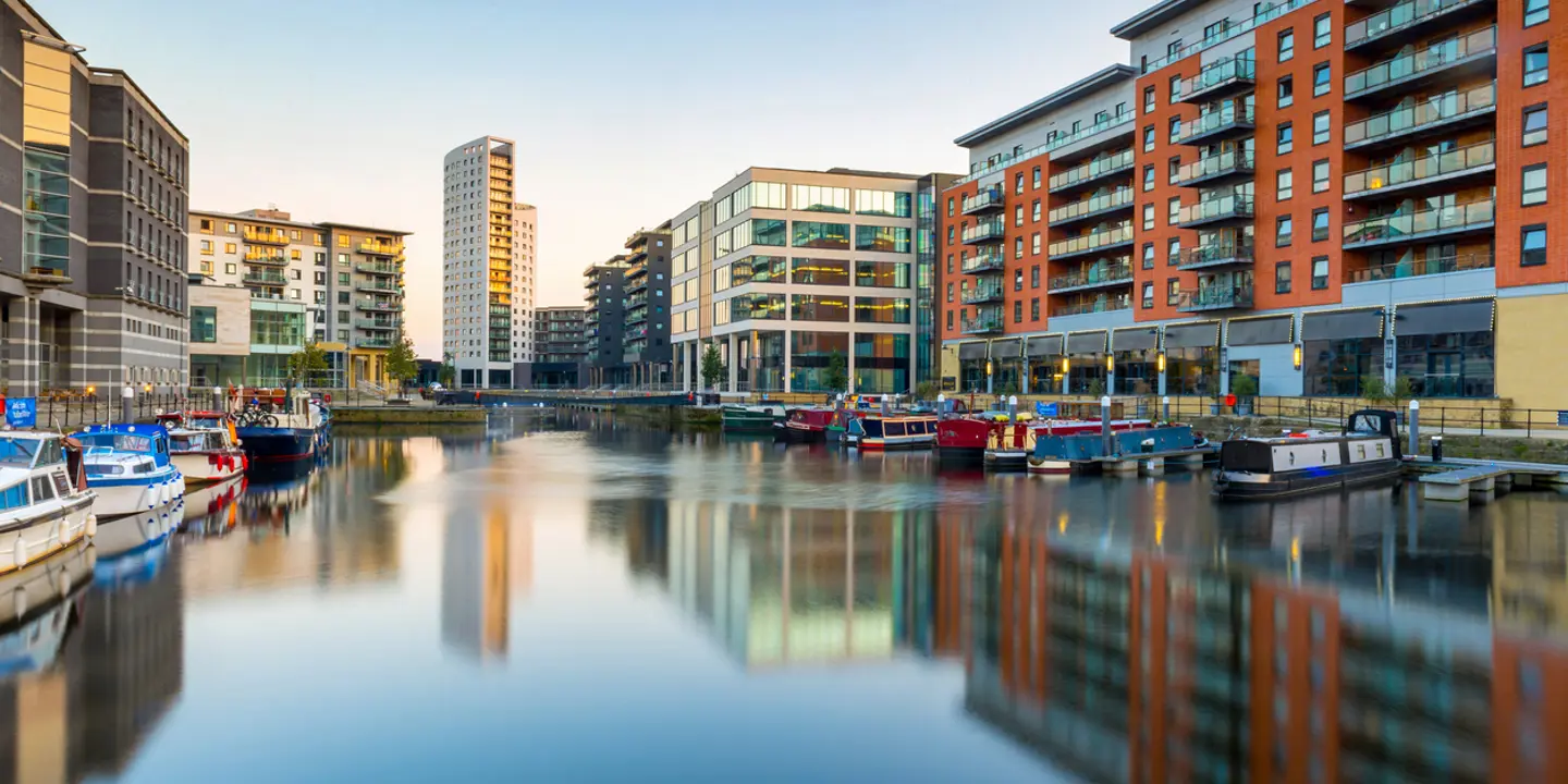 Urban skyline reflecting on a serene body of water.