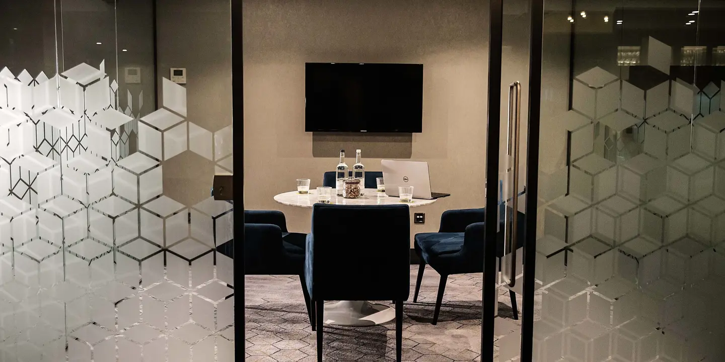 Conference room featuring a table and chairs.